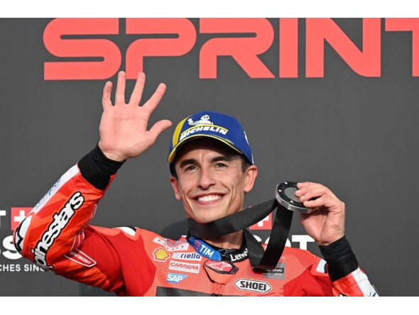 Ducati Lenovo Team's Spanish MotoGP rider Marc Marquez celebrates on the podium after finishing in second place during the MotoGP sprint race. (Photo by Toshifumi Kitamura / AFP)