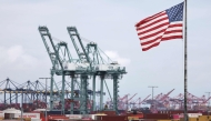 An American flag flies in front of shipping containers and cranes at the Port of Los Angeles on September 26, 2025 in Los Angeles, California. Mario Tama/Getty Images/AFP 