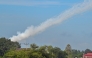 Smoke is pictured in the air from a multi-rocket launcher near the Cambodia-Thailand border in Oddar Meanchey province on July 25, 2025. (Photo by TANG CHHIN Sothy / AFP)