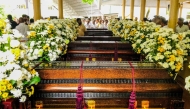 People gather near the coffins of Buddhist monks during a funeral ceremony at the Na Uyana Monastery in Melsiripura on September 27, 2025. (Photo by AFP)