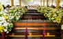 People gather near the coffins of Buddhist monks during a funeral ceremony at the Na Uyana Monastery in Melsiripura on September 27, 2025. (Photo by AFP)
