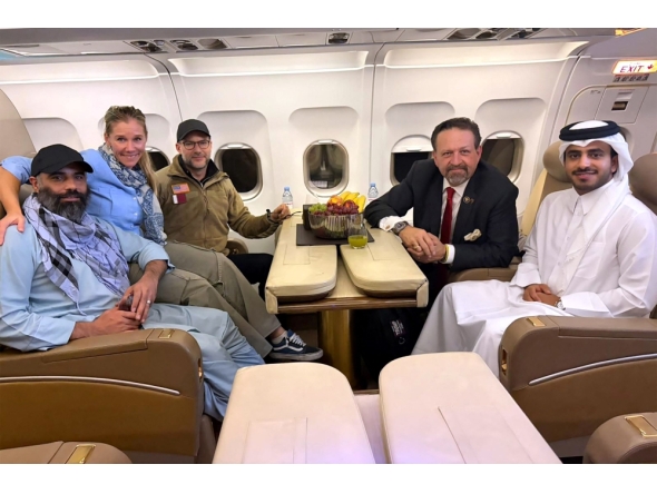 According to AFP, this handout picture released by Qatar's Ministry of Foreign Affairs (MoFA) shows American citizen Amir Amiri (left), along with US and Qatar officials. The group was onboard an aircraft following Amiri's release from detention in Kabul, Afghanistan. (Photo by AFP through MoFA handout)



