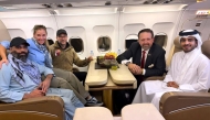 According to AFP, this handout picture released by Qatar's Ministry of Foreign Affairs (MoFA) shows American citizen Amir Amiri (left), along with US and Qatar officials. The group was onboard an aircraft following Amiri's release from detention in Kabul, Afghanistan. (Photo by AFP through MoFA handout)



