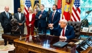US President Donald Trump speaks with the press during the signing of executive orders in the Oval Office, in Washington DC, on September 25, 2025. (Photo by Demetrius Freeman/The Washington Post)