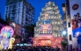 Devotees throng at the entrance during a visit to the 'Pandal' (temporary structure for worship) in Kolkata on September 27, 2025. (Photo by Dibyangshu Sarkar / AFP)