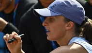 Poland's Iga Swiatek signs autographs for fans after her women's singles match against Colombia痴 Camila Osorio at the China Open tennis tournament in Beijing on September 29, 2025. (Photo by Pedro Pardo / AFP)