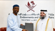 Undersecretary of the Ministry of Awqaf and Islamic Affairs H E Dr. Sheikh Khalid bin Mohammed bin Ghanem Al Thani (right) and IIFA Secretary-General H E Prof. Dr. Koutoub Mustapha Sano exchanging documents after signing the MoU.