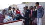 Beneficiaries receiving boats provided by the QRCS.