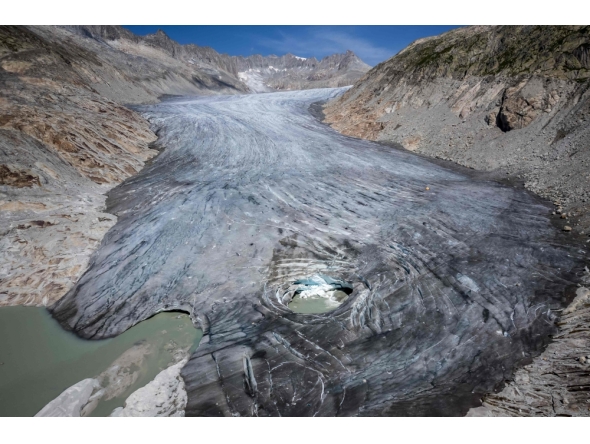 (Files) An aerial photograph taken on August 24, 2023 above Gletsch, in the Swiss Alps shows a hole in the part of the Rhone Glacier revealing its glacial lake due to the melting of the glacier.  (Photo by Fabrice Coffrini / AFP)