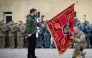 This handout photograph taken and released by the Ukrainian Presidential Press Service on October 1, 2025, shows Ukraine's President Volodymyr Zelensky holding a flag insignia as a serviceman pays his respect during a ceremony marking Defenders' Day, a holiday honoring veterans and fallen members of the Ukrainian armed forces. (Photo by Handout  / AFP)