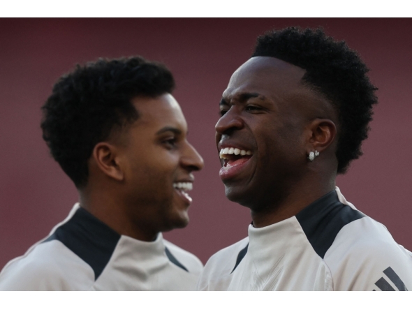 File: Real Madrid's Brazilian forward #11 Rodrygo (left) and Real Madrid's Brazilian forward #07 Vinicius Junior take part in a training session at the Emirates stadium in London on April 7, 2025. (Photo by Adrian Dennis / AFP)