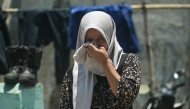 A relative of a missing student mourns as rescuers search for survivors at the Al Khoziny Islamic boarding school in Sidoarjo, East Java province on October 2, 2025. (Photo by Juni Kriswanto / AFP)
 