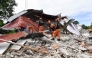 Rescuers search for three people who were reported missing under the rubble of a collapsed building in Bogo City on October 1, 2025. (Photo by Ted Aljibe / AFP)