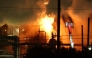 A firefighting crew works to contain a fire at the Fire Chevron Products Company El Segundo Refinery in the early morning hours on October 3, 2025, in El Segundo, California, following an explosion at the oil refinery that occurred late on October 2. Photo by Patrick T. Fallon / AFP