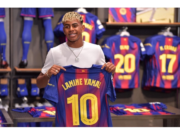 Barcelona's Spanish forward Lamine Yamal poses holding his new #10 jersey at the Camp Nou stadium's shop on July 16, 2025 in Barcelona. (Photo by Manaure Quintero / AFP)


