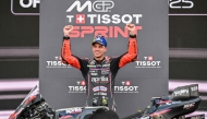 Aprilia Racing team's Italian MotoGP rider Marco Bezzecchi celebrates on the podium after winning the Sprint Race at the MotoGP Indonesian Grand Prix on October 4, 2025. C (Photo by Sonny Tumbelaka / AFP)