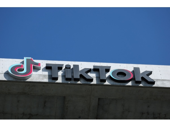 The TikTok logo is displayed on signage outside TikTok social media app company offices in Culver City, California on September 30, 2025. Photo by Patrick T. Fallon / AFP