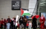 Demonstrators including one with a Palestinian flag gather at Museumplein for a 