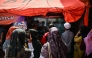 Relatives of missing students watch a live broadcast of the rescue operation near the collapsed Al Khoziny Islamic boarding school in Sidoarjo, East Java, on October 6, 2025, as recovery efforts continue. Photo by JUNI KRISWANTO / AFP
