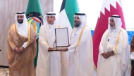 Minister of Awqaf and Islamic Affairs H E Ghanem bin Shaheen bin Ghanem Al-Ghanim (first right) looks on as Undersecretary of the Ministry of Awqaf and Islamic Affairs Dr. Sheikh Khalid bin Mohammed bin Ghanem Al Thani is honoured by Minister of Awqaf and Islamic Affairs of Kuwait H E Dr. Mohammed Ibrahim Al Wasmi. 