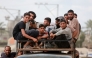 Displaced Palestinians ride a vehicle south of Deir El-Balah in the Central Gaza Strip yesterday.  ( AFP)