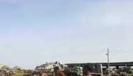 A grab from a UGC video posted on the X platform on August 22, 2023 reportedly shows members of the Sudanese army firing at Rapid Support Forces (RSF) fighters in what they say is the al-Shajara military base in Khartoum. (Photo by UGC / AFP)
