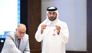 An official picks a team during the official draw ceremony.