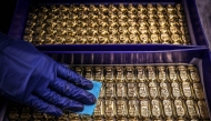 (Files) A worker polishes gold bullion bars at the ABC Refinery in Sydney on August 5, 2020. (Photo by David Gray / AFP)