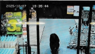 This handout photo taken on October 7, 2025 and released by Gunma Prefectural Police via Jiji Press shows a CCTV camera footage of a bear walking inside a supermarket in Numata, Gunma prefecture. (Photo by various sources / AFP) 