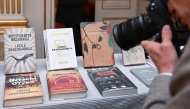 A photographer takes photos of Books of Hungarian writer Laszlo Krasznahorkai, the winner of the 2025 Nobel Prize in Literature, on display at the Swedish Academy in Stockholm, Sweden, on October 9, 2025. (Photo by Jonathan Nackstrand / AFP) 