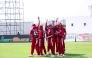 Qatar players celebrate after taking a wicket.