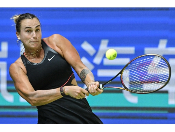 Belarus’ Aryna Sabalenka hits a return to Kazakhstan's Elena Rybakina during their women’s singles quarter-final match at the Wuhan Open tennis tournament in Wuhan, on October 10, 2025. (Photo by Adek Berry / AFP)