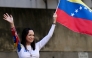 (Files) Venezuelan opposition leader Maria Corina Machado waves a national flag in Caracas on January 9, 2025. (Photo by Juan Barreto / AFP)