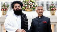 This handout photograph taken and released on October 10, 2025 shows India's Foreign Minister Subrahmanyam Jaishankar (right) and his Afghan counterpart Amir Khan Muttaqi during a bilateral meeting in New Delhi. (Photo by India's Ministry of External Affairs / AFP) 
