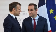 France's President Emmanuel Macron (left) with France's Minister of Armed Forces Sebastien Lecornu after delivering a speech to army leaders at l’Hôtel de Brienne in Paris on July 13, 2025. (Photo by Ludovic Marin / POOL / AFP)
