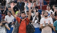 Serbia's Novak Djokovic acknowledges spectators after losing in his men's singles semi-final match against Monaco's Valentin Vacherot on October 11, 2025. (Photo by Hector Retamal / AFP)