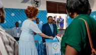 Paul Biya, President of Cameroon and presidential candidate for the Cameroon People's Democratic Movement (CPDM), watches as Cameroon First Lady Chantal Biya casts her ballot at a polling station in Yaounde on October 12, 2025 during Cameroon's presidential election. (Photo by Daniel Beloumou Olomo / AFP)