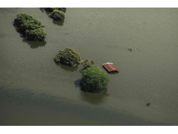 This aerial view taken during a Mexican Navy flyover shows a flooded house after heavy rains in Poza Rica, Veracruz state, Mexico on October 11, 2025. (Photo by Hector Quintanar / AFP)
 