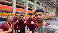 Qatar table tennis players and officials pose for a photo.