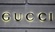 This picture taken on December 19, 2017 shows a logo outside the fashion house and luxury goods Gucci shop on the Avenue Montaigne in Paris, ahead of Christmas. Photo by STEPHANE DE SAKUTIN / AFP

