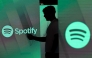 File: A man checks his smartphone whilst standing amongst illuminated screens bearing the Spotify Technology SA logo in this arranged photograph in London, UK, on Tuesday, June 26, 2018. (Photo by Chris Ratcliffe/Bloomberg)
