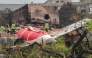 An investigation team inspects the wreckage of Air India flight 171 a day after it crashed in a residential area near the airport, in Ahmedabad on June 13, 2025. Photo by Sam PANTHAKY / AFP.

