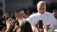 Pope Leo XIV greets the crowd from the Popemobile after a mass for the canonization of seven new Saints at St Peter's square in The Vatican, on October 19, 2025. (Photo by Filippo Monteforte / AFP)