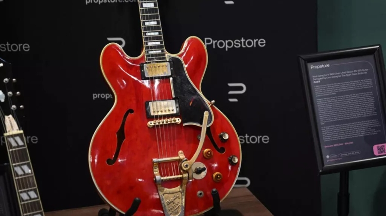 The cherry-red Gibson ES-355 guitar is famous for having been damaged during a fight that led to the Oasis band breaking up in August 2009. (Justin Tallis / AFP)
