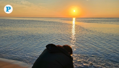 A man captures the rising sun over Sealine in Mesaieed, as morning temperatures cool across Qatar. Photo by Marivie Alabanza / The Peninsula