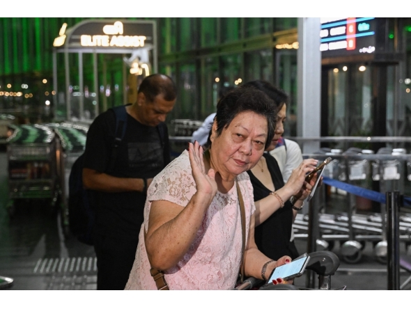 Monica Liu, an Indian citizen and entrepreneur with origins from China, prepares to depart for Guangzhou, from the Netaji Subhas Chandra Bose International Airport in Kolkata on October 26, 2025. (Photo by Dibyangshu Sarkar / AFP)
