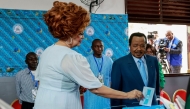 Paul Biya with wife Chantal Biya (L) cast their ballot at a polling station in Yaounde on October 12, 2025 during Cameroon's presidential election. Photo by Daniel Olomo / AFP