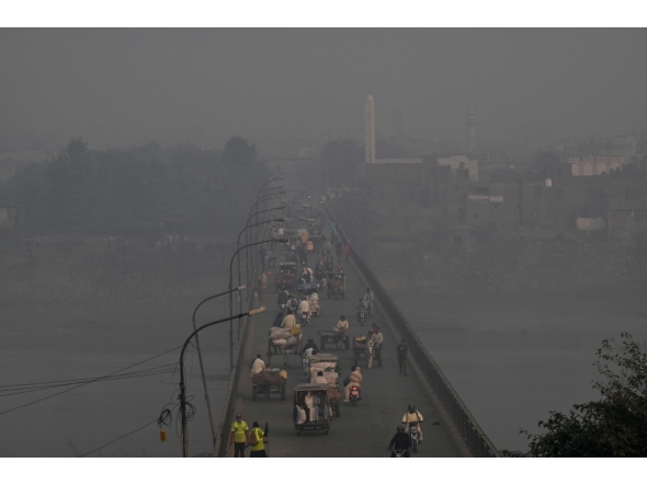 Commuters drive across a bridge amid dense smog in Lahore on October 27, 2025. (Photo by Arif ALI / AFP). Photo used for representational purposes only.