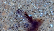 (FILES) This handout image courtesy of Maxar Technologies taken on April 16, 2025 and released on April 17, 2025, shows fire and smoke at Zamzam camp near the besieged Darfur city of El-Fasher. (Photo by Satellite image 2025 Maxar Technologies / AFP)