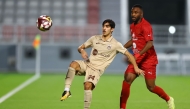 Al Rayyan's Ali Hassan Al-Qahtani (left) and Al Duhail's Ismail Mohamad in action.